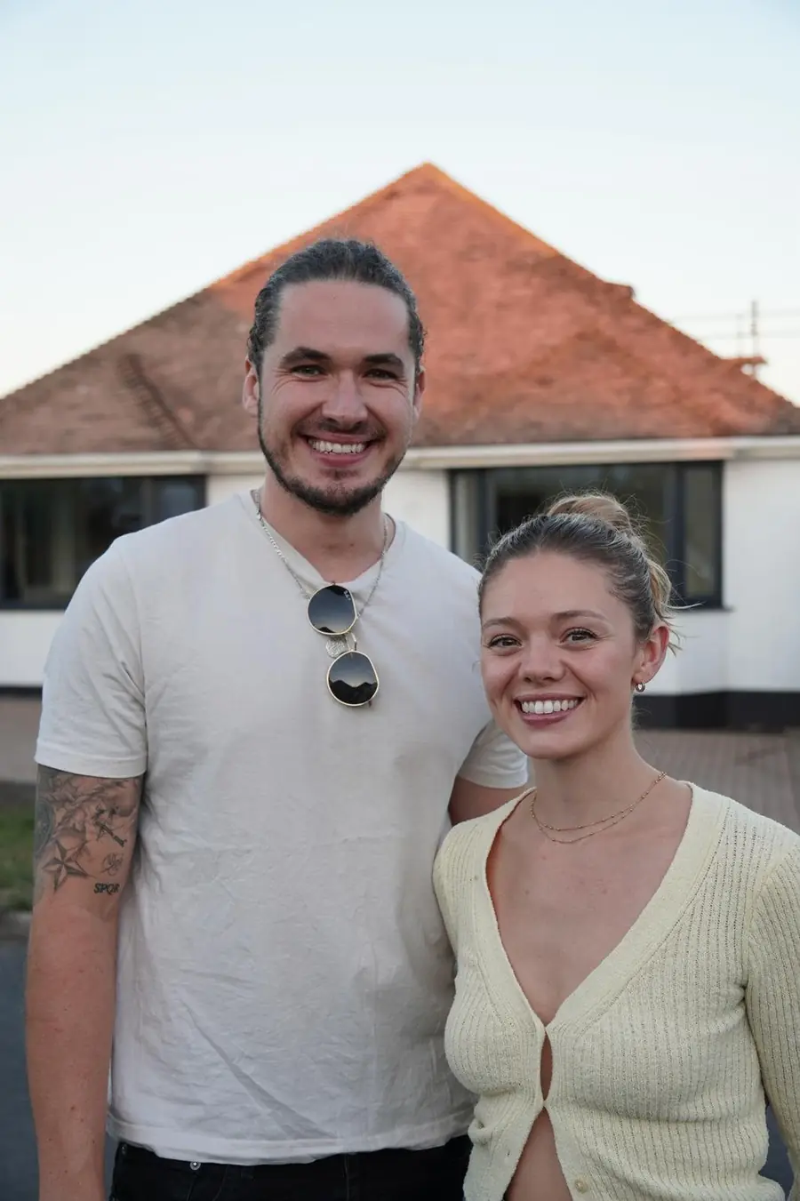 Erin and Alex outside a house