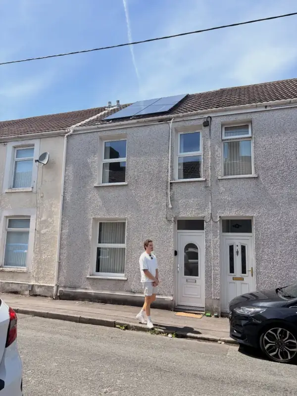 Alex outside a terraced house on a South Wales viewing day